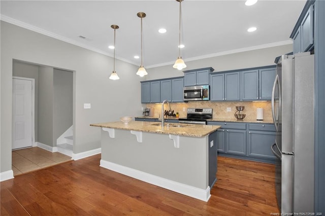 kitchen with stainless steel appliances, backsplash, ornamental molding, light stone counters, and a breakfast bar