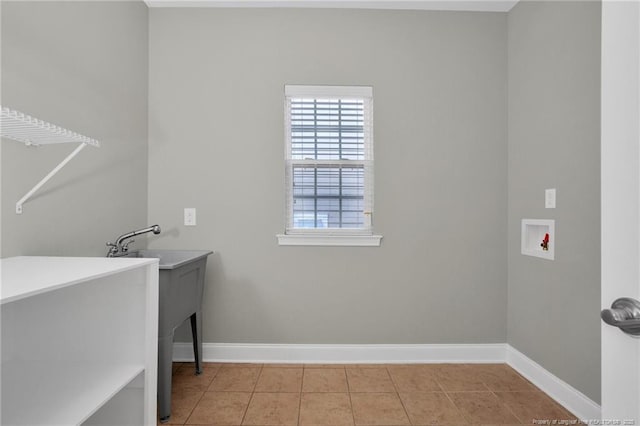 laundry room featuring hookup for a washing machine, baseboards, and tile patterned flooring