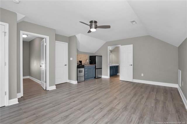 unfurnished living room featuring a ceiling fan, light wood-style floors, lofted ceiling, and baseboards
