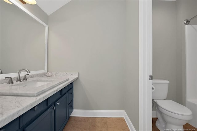 bathroom with baseboards, toilet, vanity, tile patterned flooring, and a shower