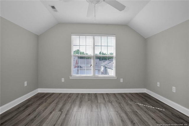 additional living space featuring lofted ceiling, dark wood-type flooring, a ceiling fan, and baseboards