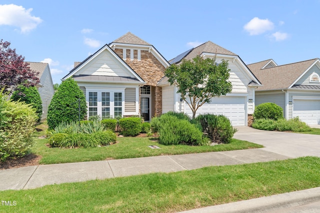 204 Dowington Ln, Cary, NC 27519 - view of front of property with concrete driveway, an attached garage, a standing seam roof, a front yard, and roof with shingles