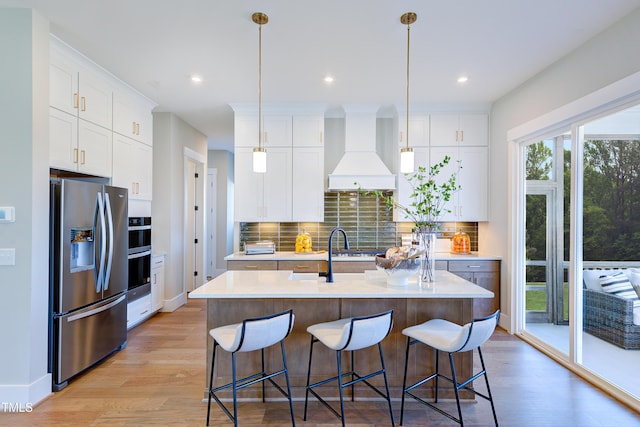 kitchen with stainless steel appliances, custom range hood, light countertops, decorative backsplash, and recessed lighting