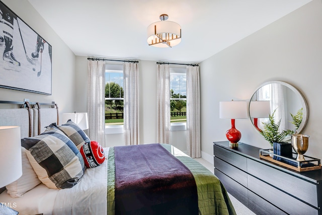 bedroom featuring baseboards, a chandelier, and carpet floors