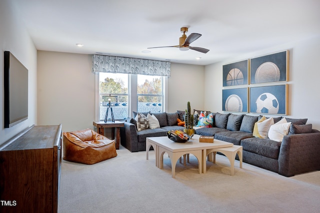living room with ceiling fan and carpet flooring