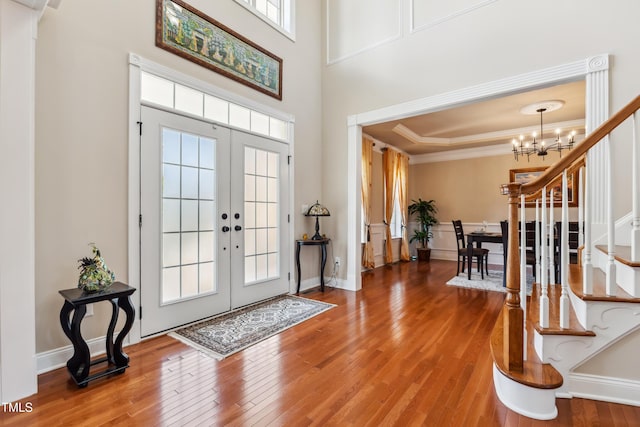 3404 Mount Pisgah Way, Cary, NC 27519 - entrance foyer with a chandelier, wood finished floors, stairs, french doors, and ornamental molding