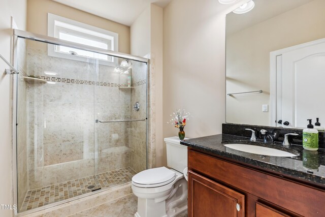 3404 Mount Pisgah Way, Cary, NC 27519 - bathroom featuring toilet, vanity, a stall shower, and tile patterned floors