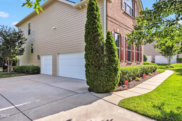 3404 Mount Pisgah Way, Cary, NC 27519 - view of side of property with a garage, driveway, and a lawn