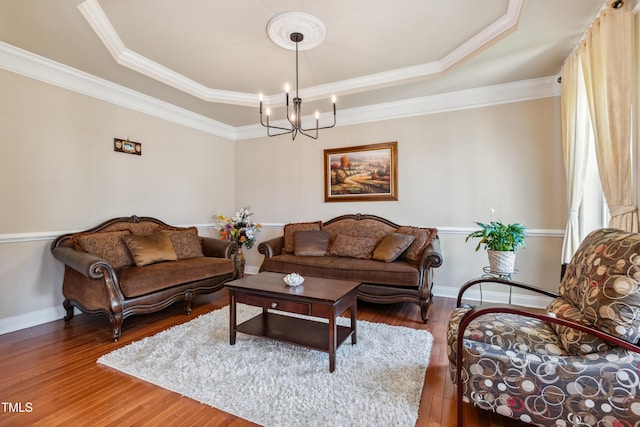 3404 Mount Pisgah Way, Cary, NC 27519 - living area featuring a tray ceiling, a chandelier, hardwood / wood-style floors, baseboards, and crown molding