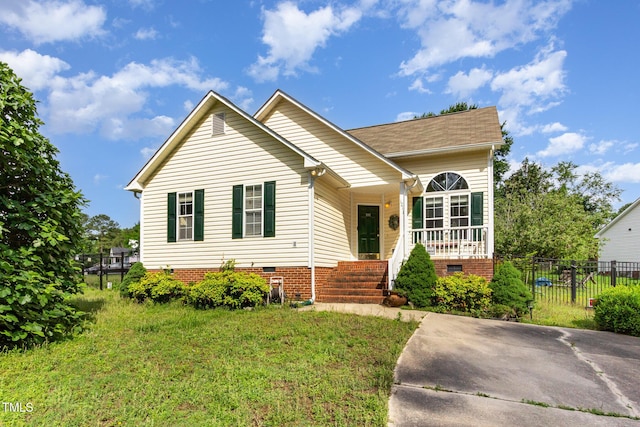 view of front of home with covered porch, crawl space, and fence