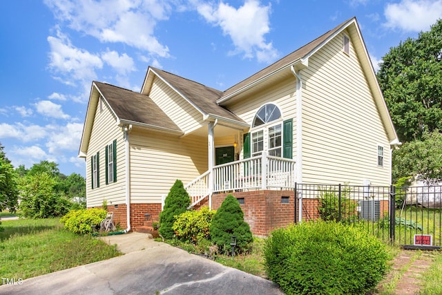 view of home's exterior with stairs, covered porch, fence, and crawl space