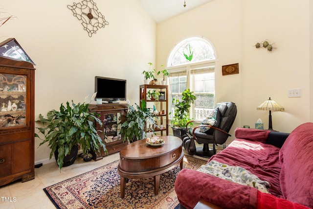 living room featuring high vaulted ceiling and tile patterned flooring