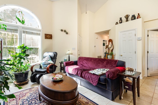 living room featuring a high ceiling and light tile patterned flooring