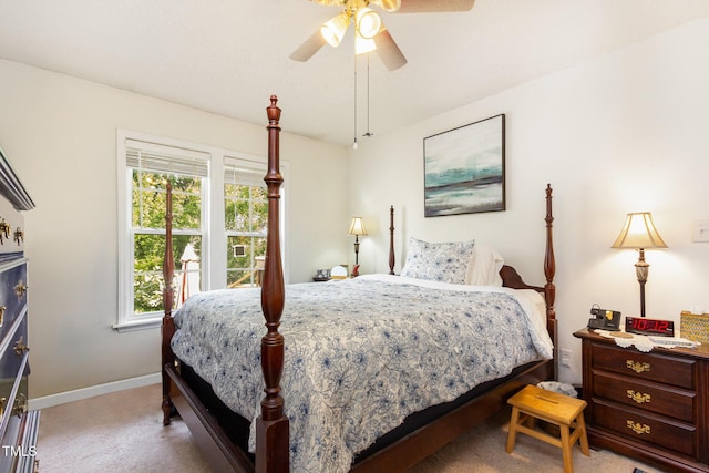 carpeted bedroom featuring baseboards and ceiling fan