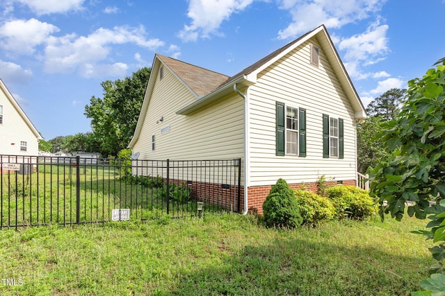 view of side of home with fence and crawl space