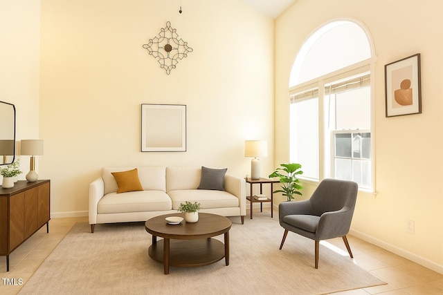 1211 Azalea Dr, Zebulon, NC 27597 - living area featuring a high ceiling, baseboards, and light tile patterned flooring