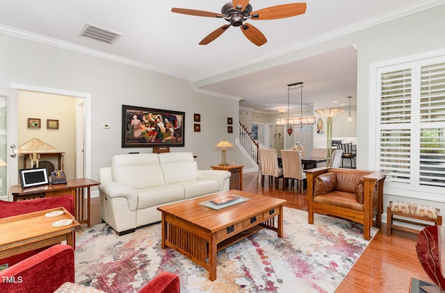 241 Serenity Hill Cir, Chapel Hill, NC 27516 - living area with wood finished floors, crown molding, ceiling fan, a chandelier, and stairway
