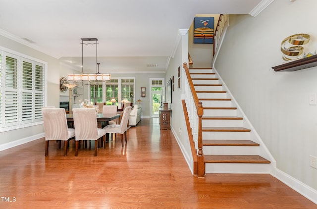241 Serenity Hill Cir, Chapel Hill, NC 27516 - dining room with stairway, wood finished floors, baseboards, crown molding, and a chandelier