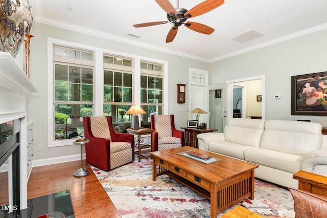 241 Serenity Hill Cir, Chapel Hill, NC 27516 - living room with crown molding, a fireplace, ceiling fan, wood finished floors, and baseboards