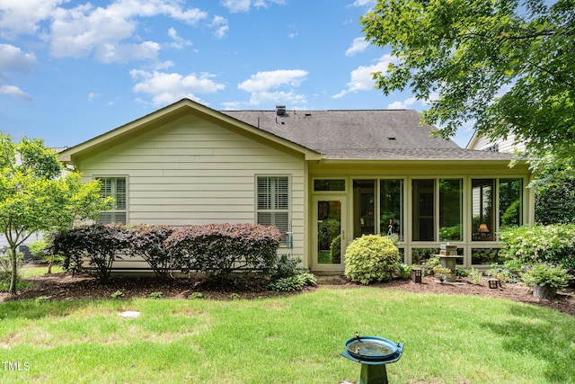 241 Serenity Hill Cir, Chapel Hill, NC 27516 - rear view of house featuring a lawn, a shingled roof, and a sunroom