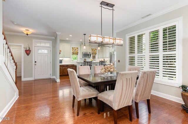 241 Serenity Hill Cir, Chapel Hill, NC 27516 - dining area with crown molding, baseboards, dark wood-style floors, stairs, and recessed lighting