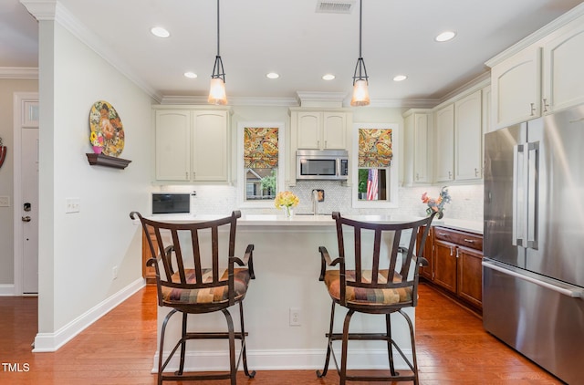 241 Serenity Hill Cir, Chapel Hill, NC 27516 - kitchen with appliances with stainless steel finishes, a breakfast bar area, decorative backsplash, crown molding, and recessed lighting