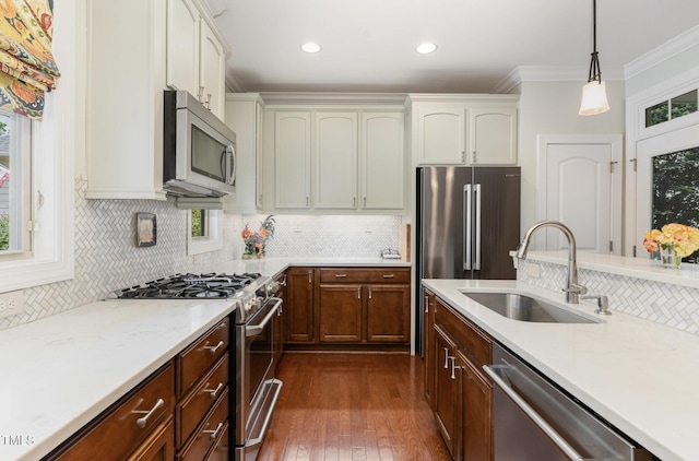241 Serenity Hill Cir, Chapel Hill, NC 27516 - kitchen featuring a sink, stainless steel appliances, tasteful backsplash, dark wood finished floors, and crown molding