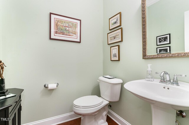 241 Serenity Hill Cir, Chapel Hill, NC 27516 - half bath with baseboards, toilet, wood finished floors, and a sink