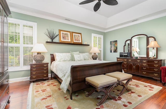 241 Serenity Hill Cir, Chapel Hill, NC 27516 - bedroom featuring multiple windows, wood finished floors, ornamental molding, a tray ceiling, and baseboards