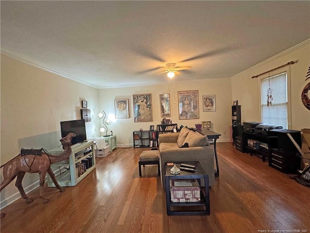 living room with wood finished floors, crown molding, a ceiling fan, and baseboards