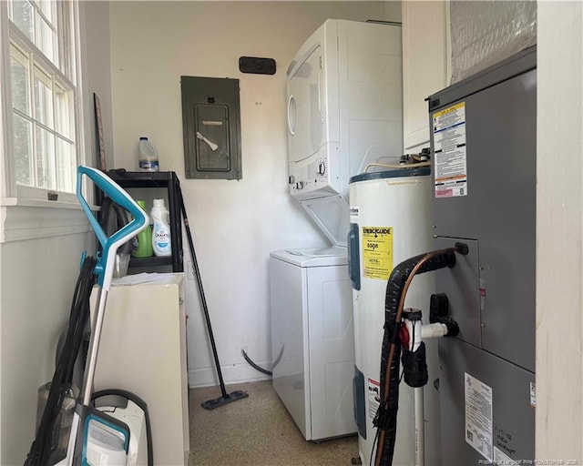 laundry area with stacked washer / drying machine, electric water heater, electric panel, and heating unit