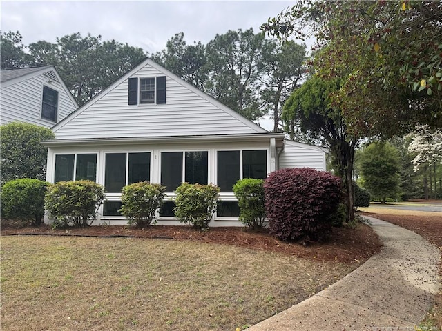view of property exterior with a yard