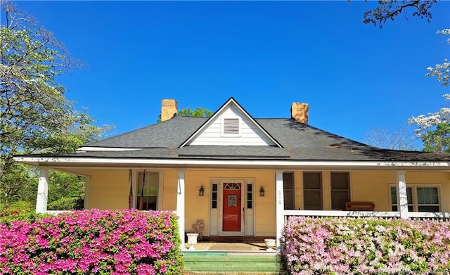 616 N Fulton St, Raeford, NC 28376 - farmhouse with a porch, a chimney, and a shingled roof