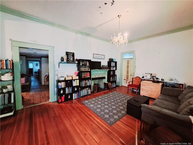 616 N Fulton St, Raeford, NC 28376 - living room featuring crown molding, wood finished floors, a fireplace, and a chandelier