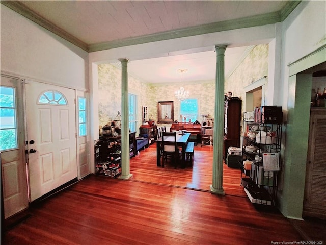 616 N Fulton St, Raeford, NC 28376 - foyer entrance with ornamental molding, dark wood-style floors, ornate columns, a chandelier, and wallpapered walls