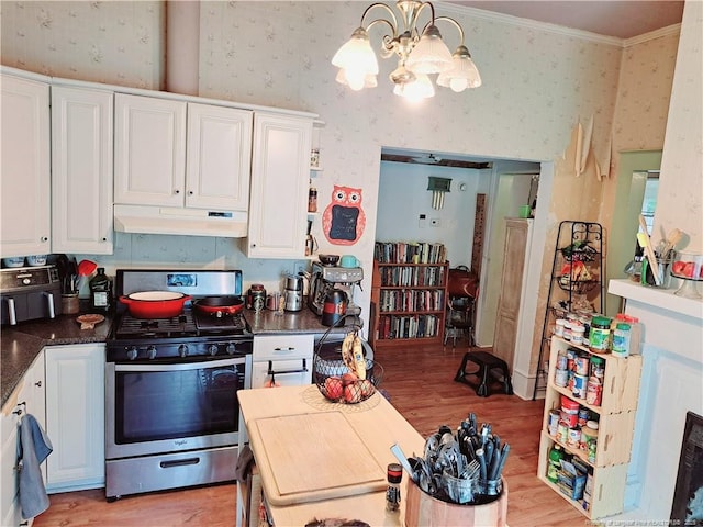 616 N Fulton St, Raeford, NC 28376 - kitchen featuring stainless steel gas range, under cabinet range hood, wallpapered walls, a chandelier, and light wood finished floors