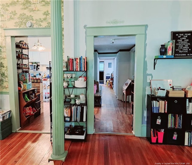 616 N Fulton St, Raeford, NC 28376 - corridor featuring wood finished floors and a chandelier
