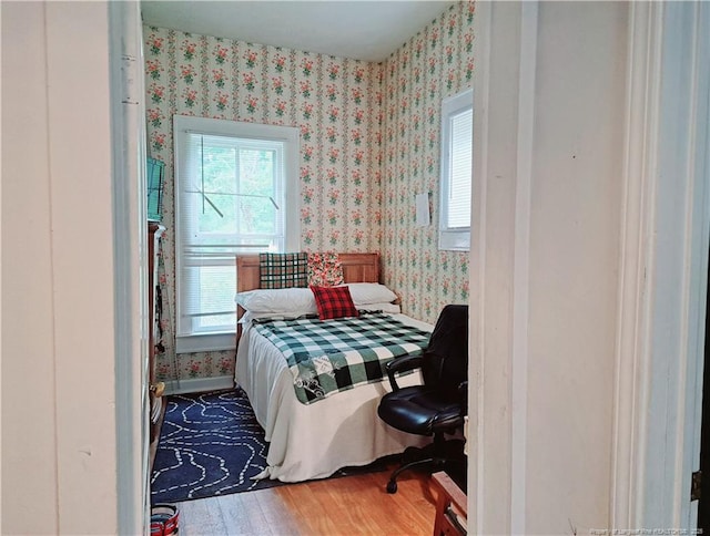 616 N Fulton St, Raeford, NC 28376 - bedroom featuring wallpapered walls and wood finished floors