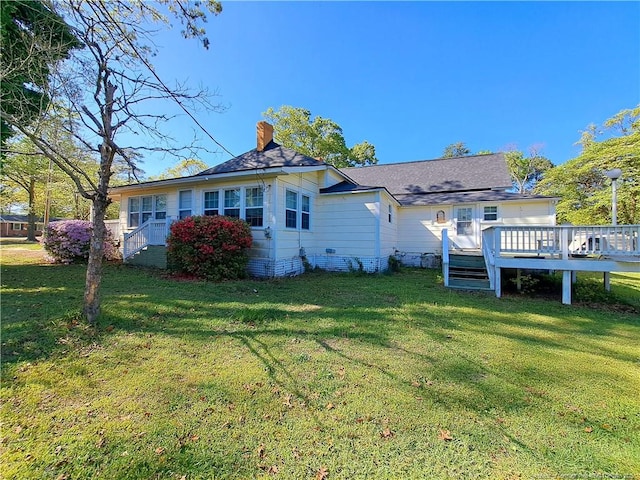 616 N Fulton St, Raeford, NC 28376 - back of property featuring a yard, a wooden deck, and a chimney