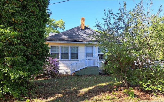 616 N Fulton St, Raeford, NC 28376 - view of side of property with roof with shingles, a chimney, and crawl space