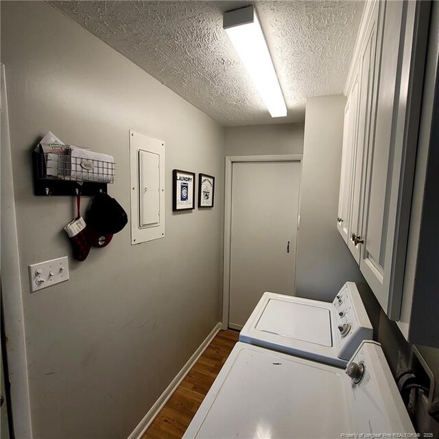 505 W 30th St, Lumberton, NC 28358 - laundry room with washer and clothes dryer, a textured ceiling, cabinet space, dark wood-style floors, and electric panel
