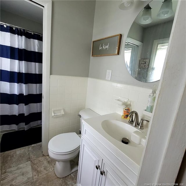 505 W 30th St, Lumberton, NC 28358 - bathroom featuring tile walls, toilet, vanity, a wainscoted wall, and a shower with curtain