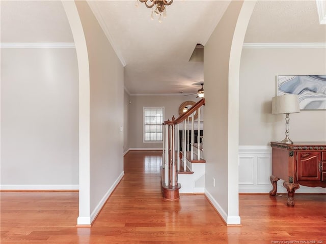 2815 Prioress Dr, Fayetteville, NC 28306 - foyer entrance with arched walkways, light wood-style floors, stairway, a ceiling fan, and crown molding