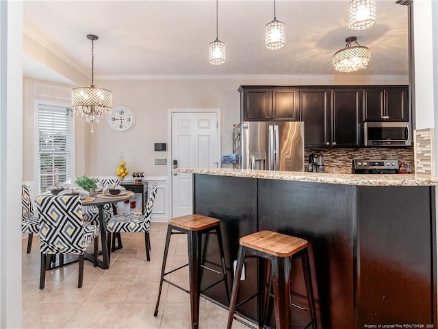 2815 Prioress Dr, Fayetteville, NC 28306 - kitchen with appliances with stainless steel finishes, ornamental molding, backsplash, hanging light fixtures, and light tile patterned flooring