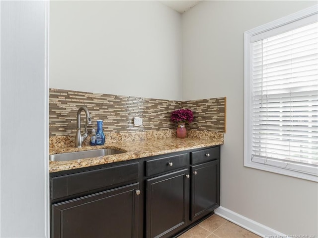 2815 Prioress Dr, Fayetteville, NC 28306 - interior space with a sink, tasteful backsplash, light tile patterned floors, and light stone countertops
