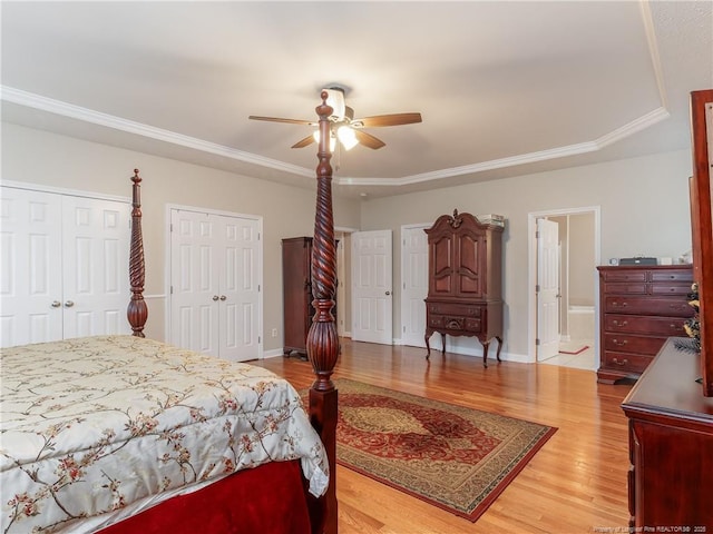 2815 Prioress Dr, Fayetteville, NC 28306 - bedroom with light wood-type flooring, a ceiling fan, crown molding, multiple closets, and baseboards