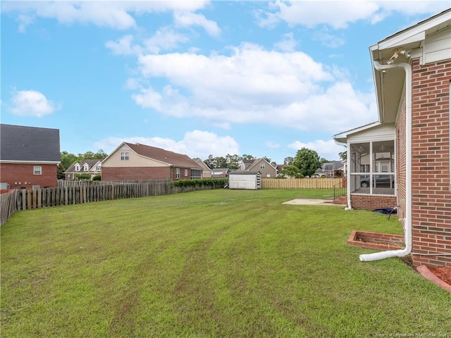 2815 Prioress Dr, Fayetteville, NC 28306 - view of yard featuring a sunroom, a storage shed, an outbuilding, and a residential view