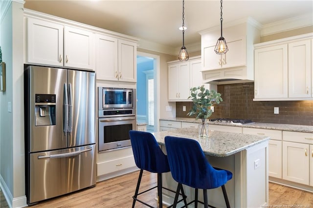 kitchen with appliances with stainless steel finishes, light wood-style floors, decorative backsplash, white cabinetry, and ornamental molding