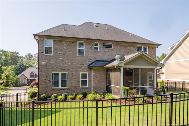 back of property featuring a sunroom and brick siding