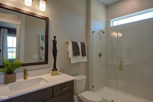 full bath with plenty of natural light, a shower stall, vanity, and toilet